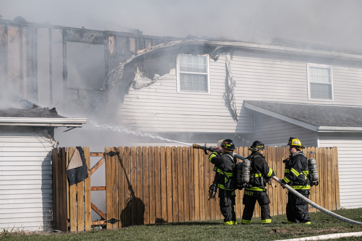 Columbus firefighters work to extinguish a large structure fire in a condominium unit at Two Worlds Condominium Association in Columbus, Ind., Wednesday, Dec. 6, 2020. Mike Wolanin | The Republic